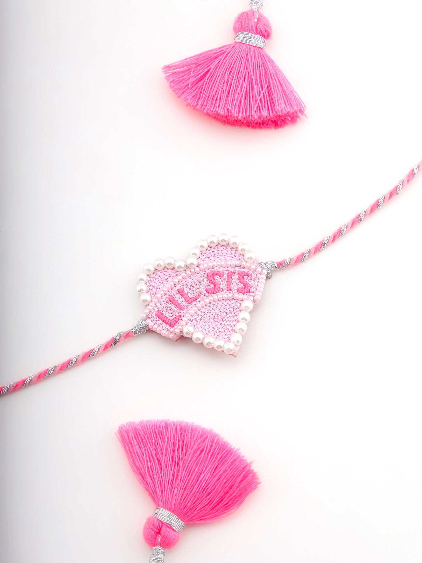 Decorative sister rakhi with heart shaped lil sis text