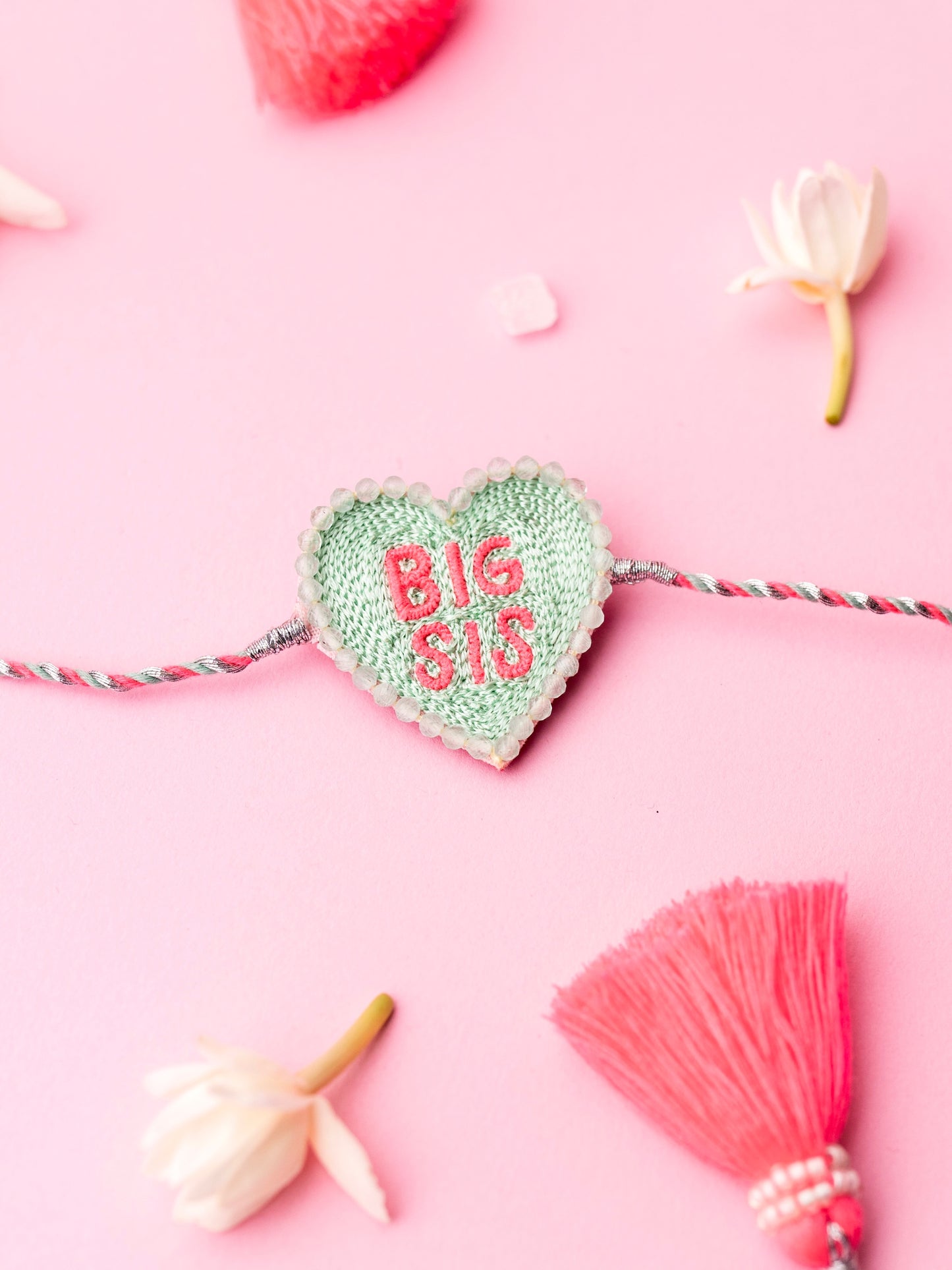 Decorative sister rakhi  with heart-shaped big sis text