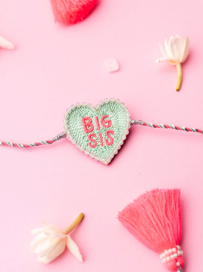 Decorative sister rakhi  with heart-shaped big sis text