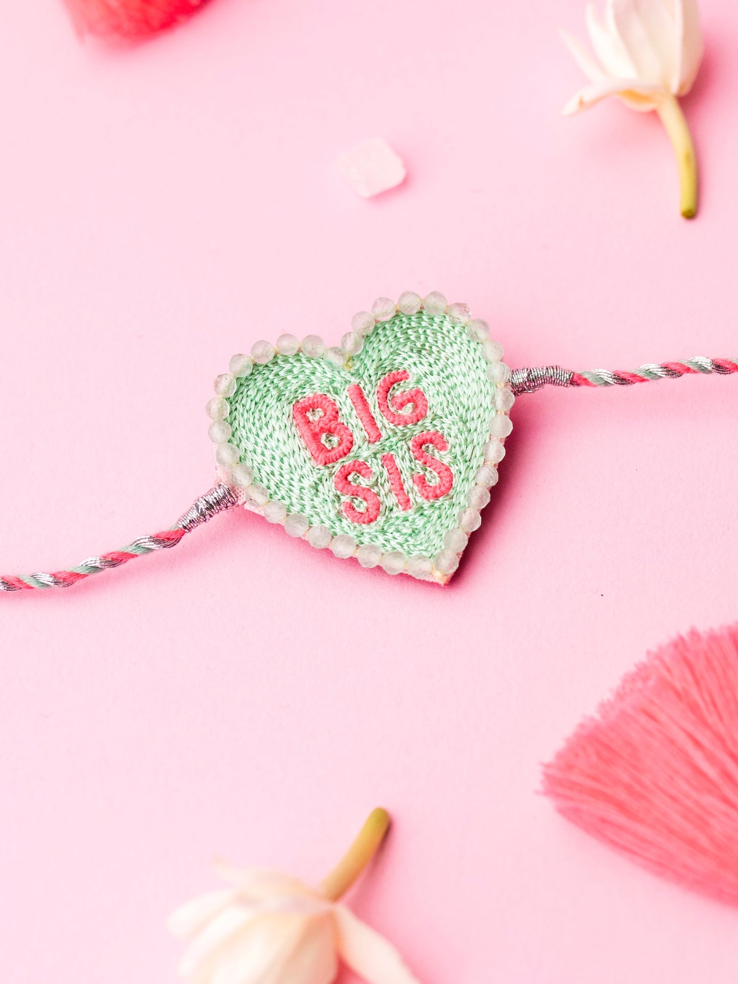 Decorative sister rakhi with heart-shaped big sis text