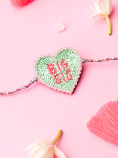Decorative sister rakhi with heart-shaped big sis text