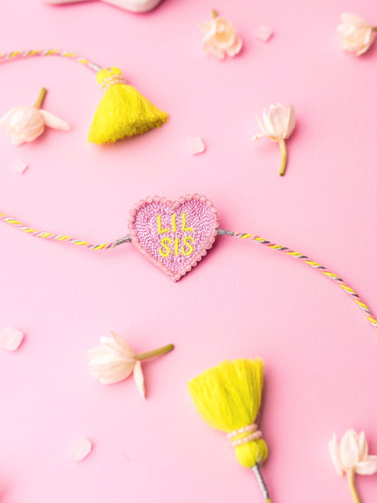 Decorative sister rakhi with heart-shaped lil sis text