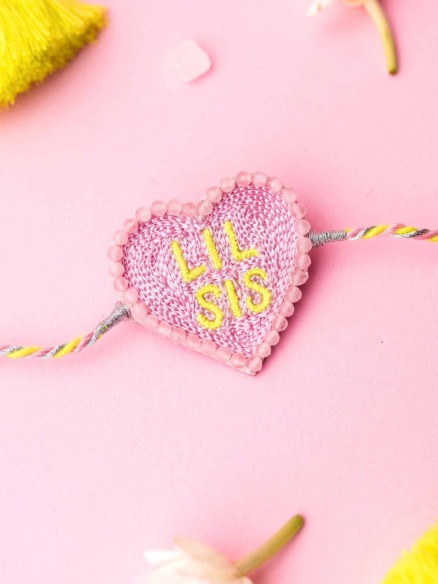 Decorative sister rakhi with heart-shaped lil sis text