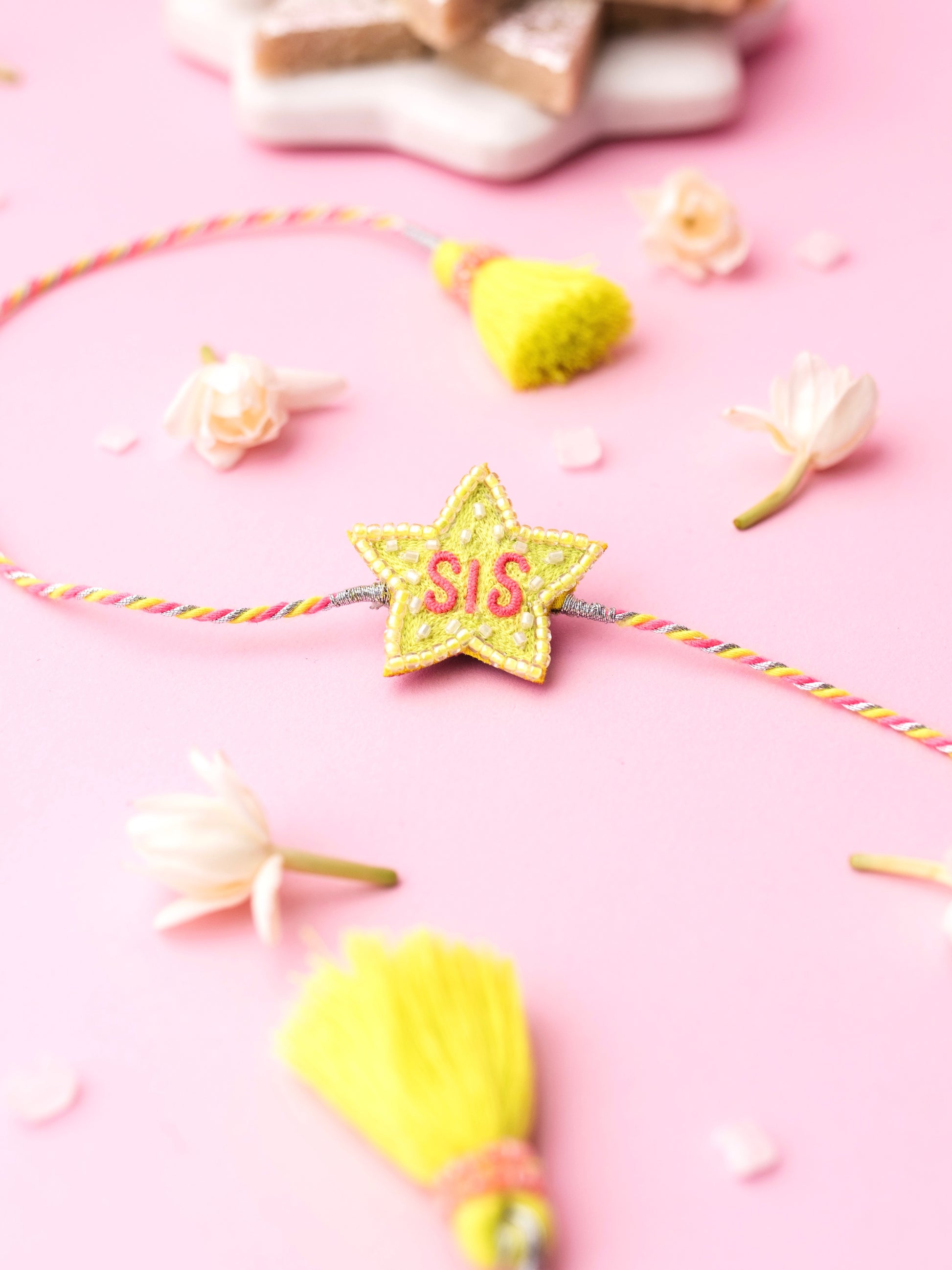 Decorative sister rakhi with star-shaped sis text