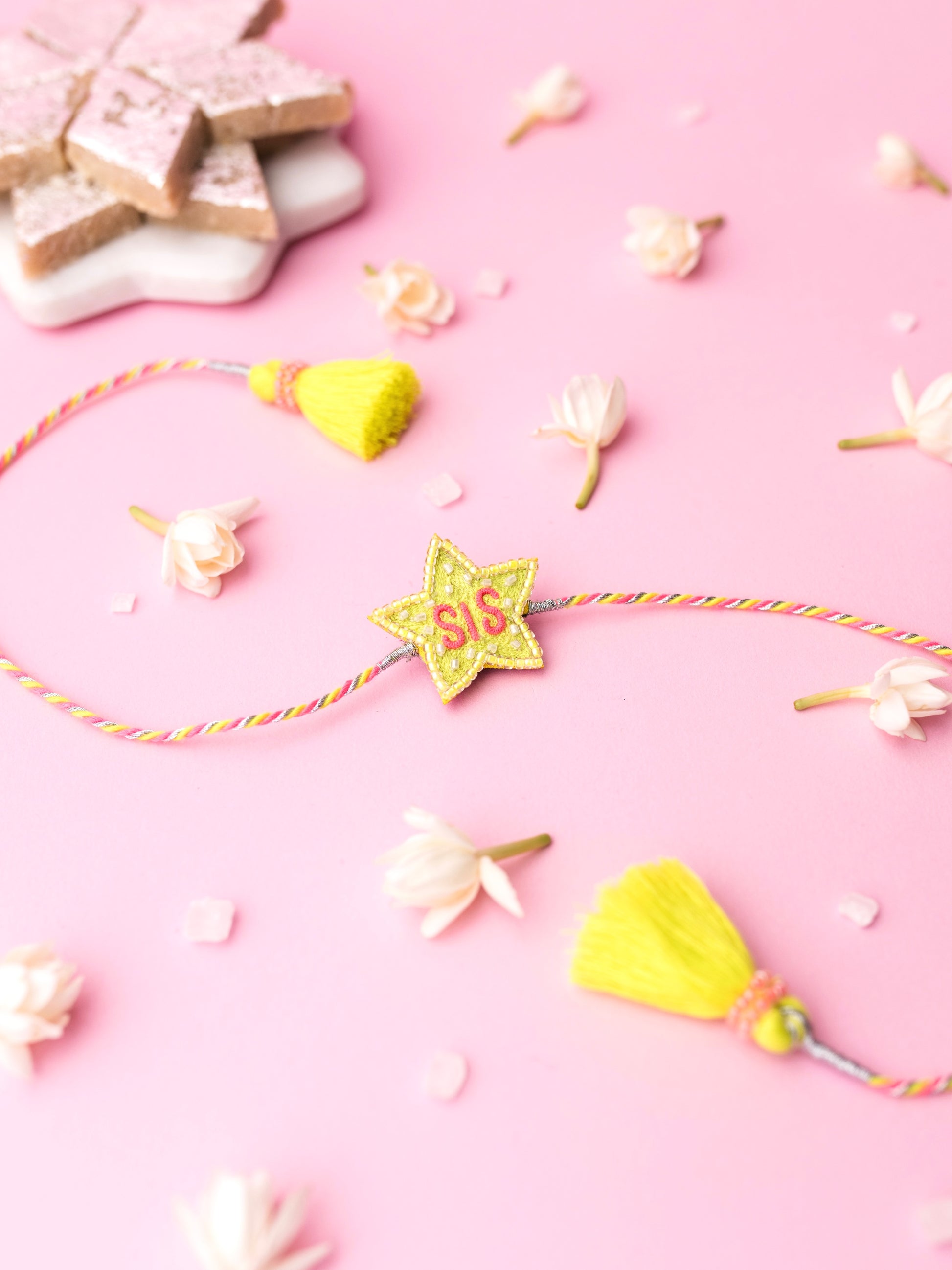 Decorative sister rakhi with star-shaped sis text