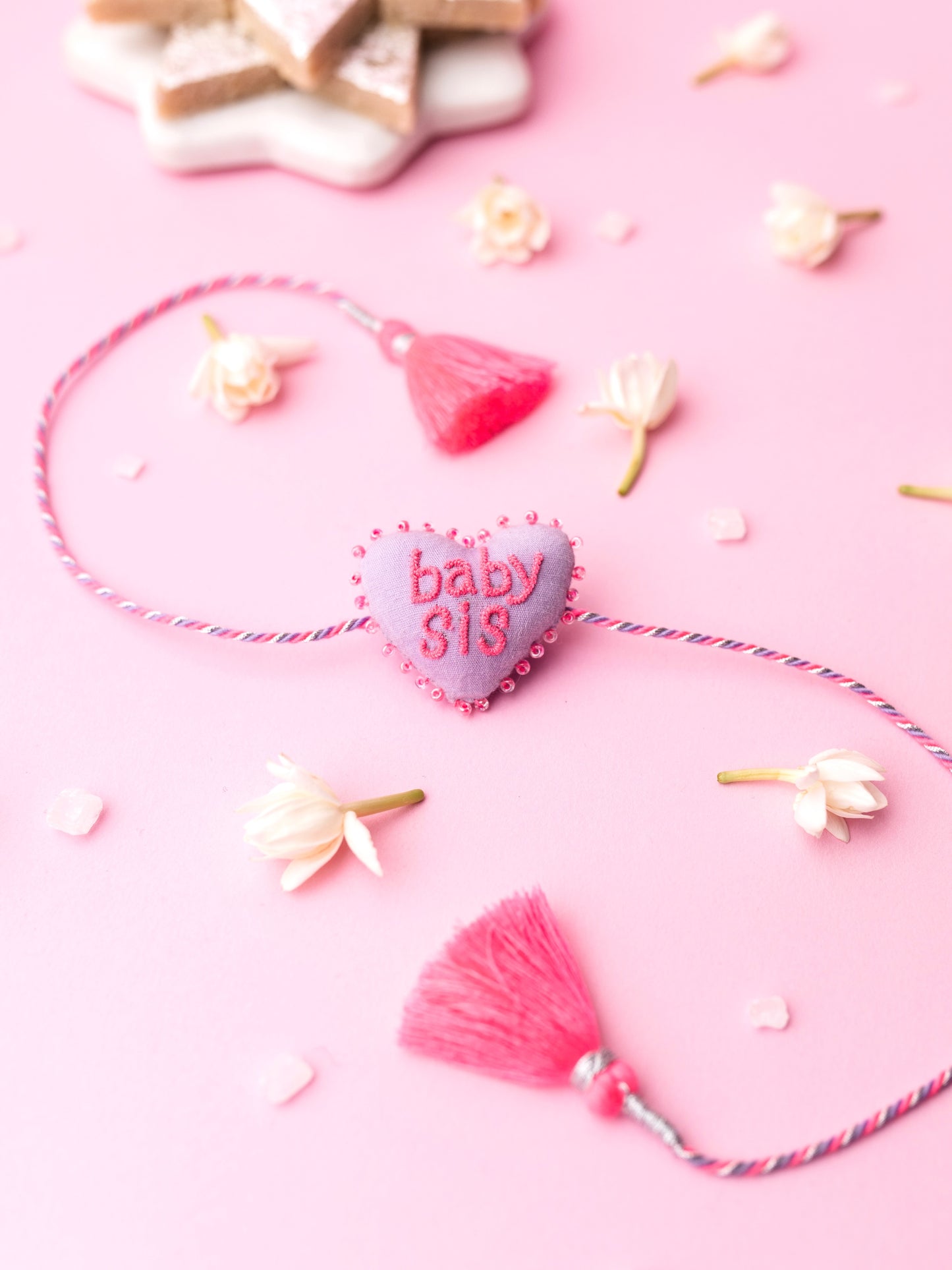 Decorative sister rakhi  with heart-shaped 3D baby sis text
