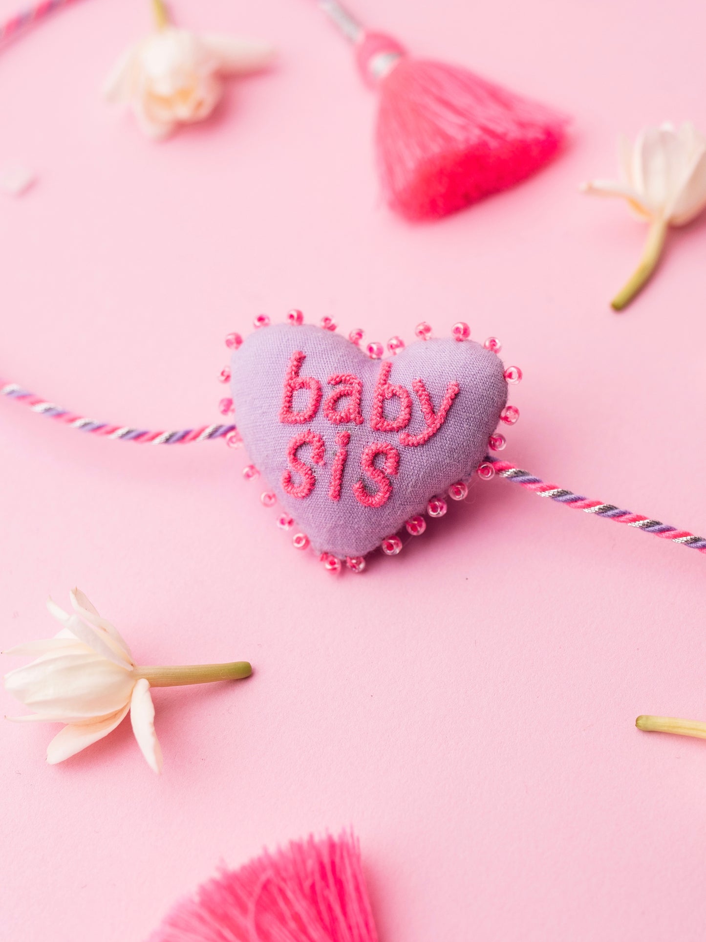 Decorative sister rakhi combo with heart-shaped 3D baby sis text