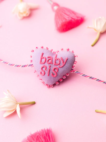 Decorative sister rakhi  with heart-shaped 3D baby sis text