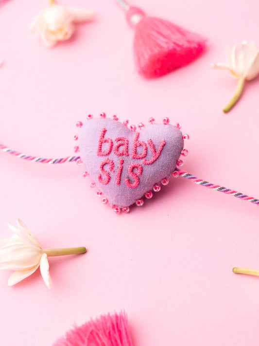 Decorative sister rakhi  with heart-shaped 3D baby sis text