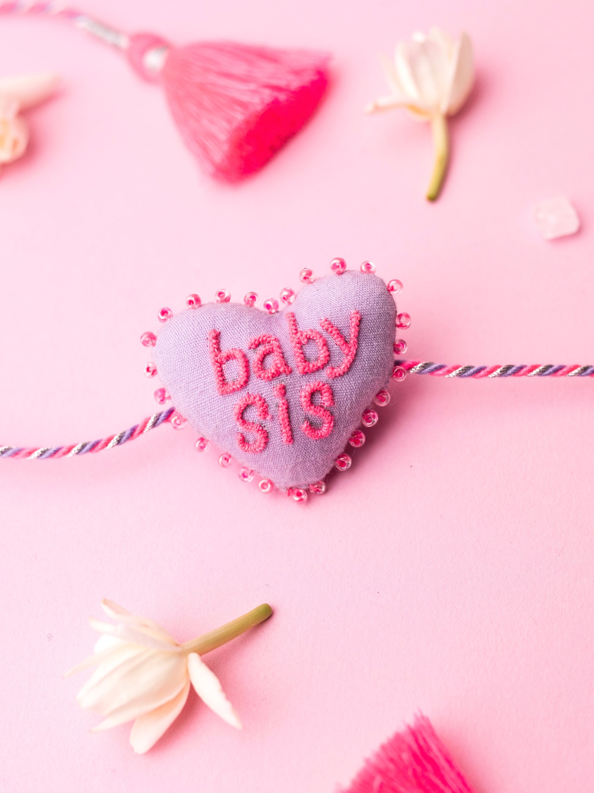 Decorative sister rakhi  with heart-shaped 3D baby sis text