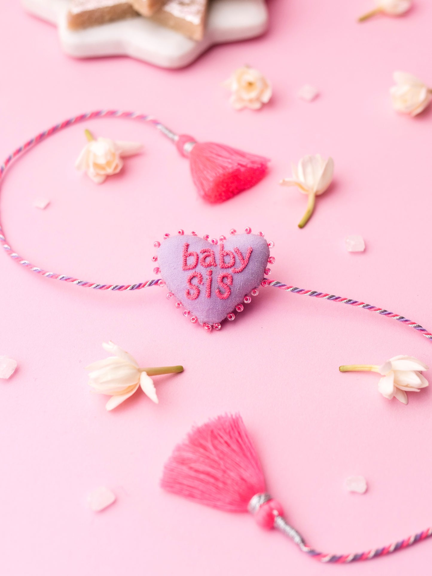 Decorative sister rakhi  with heart-shaped 3D baby sis text