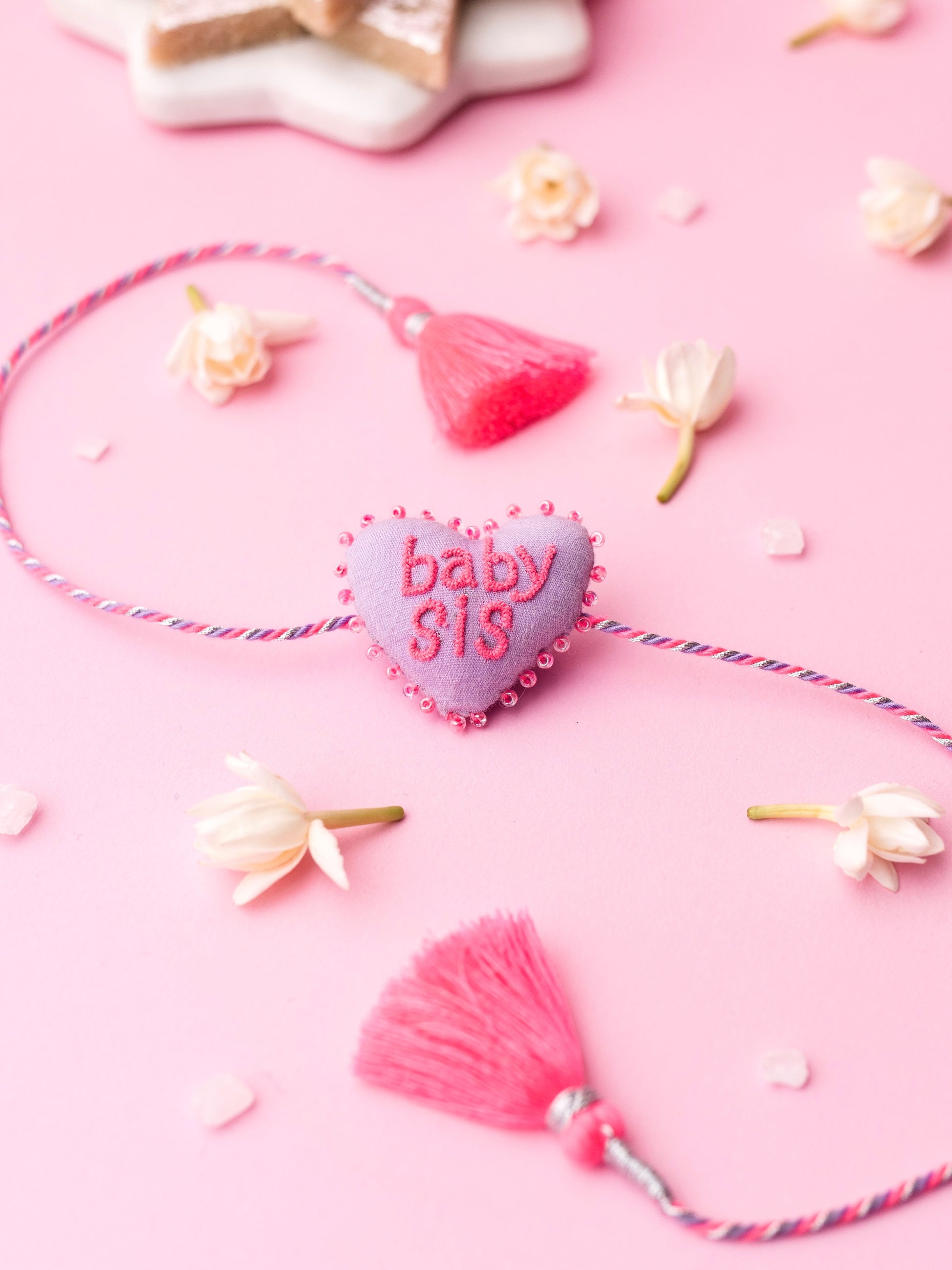 Decorative sister rakhi  with heart-shaped 3D baby sis text