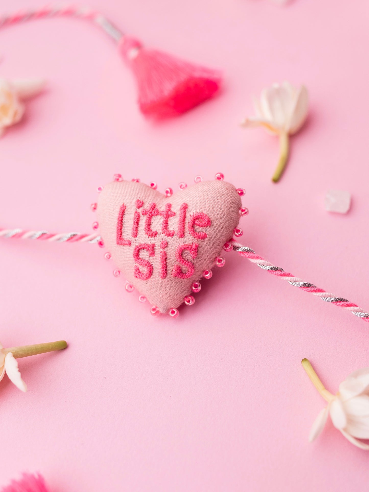 Decorative pink sister rakhi with heart-shaped 3D little sis text