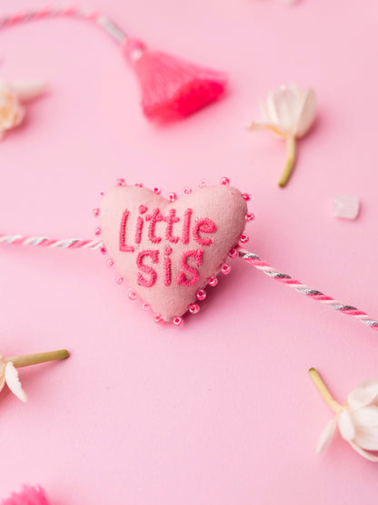 Decorative pink sister rakhi with heart-shaped 3D little sis text