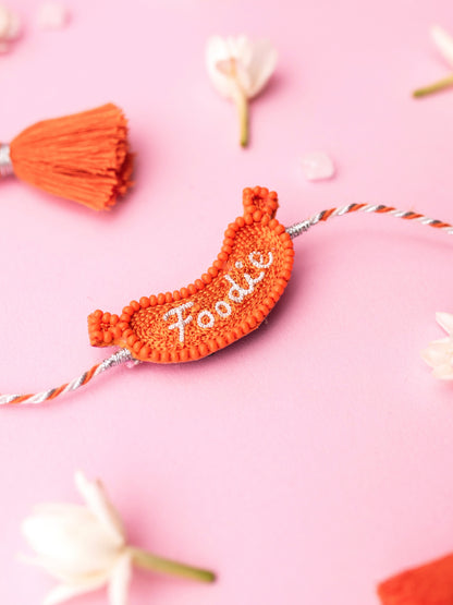 Decorative pet rakhi with foodie text