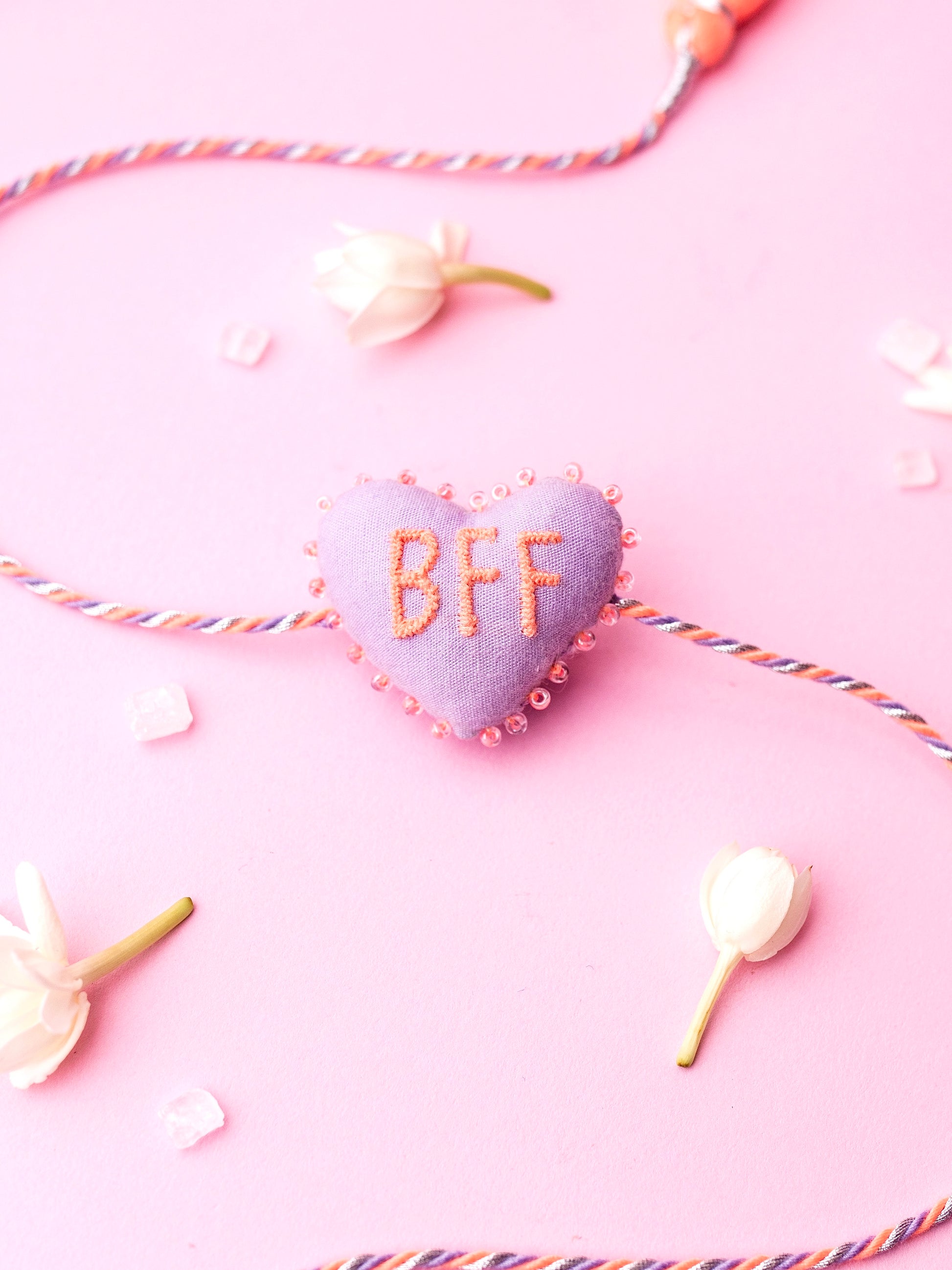 Decorative lavender sister rakhi  with heart-shaped 3D BFF text