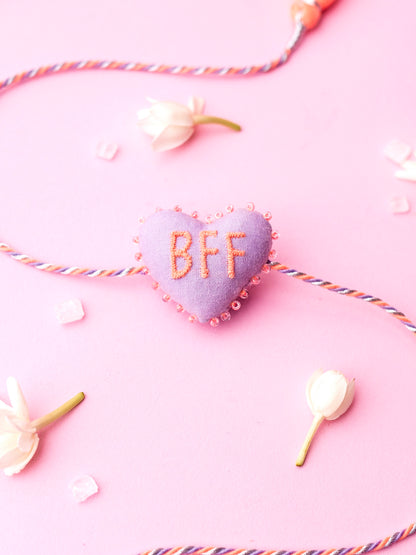 Decorative lavender sister rakhi  with heart-shaped 3D BFF text