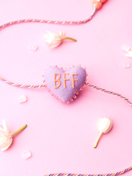 Decorative lavender sister rakhi  with heart-shaped 3D BFF text
