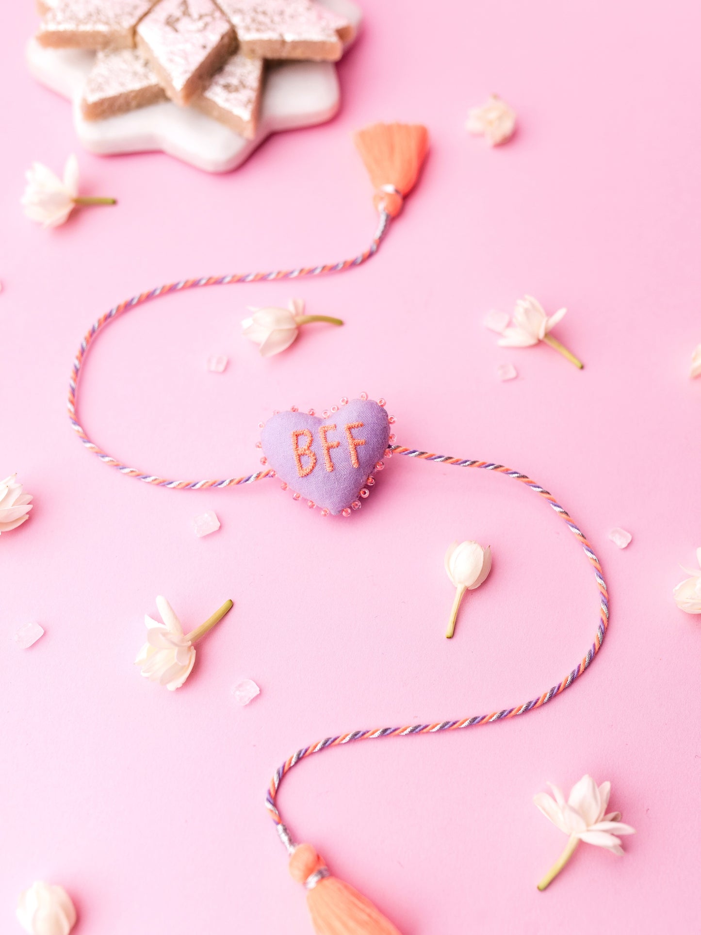 Decorative lavender sister rakhi  with heart-shaped 3D BFF text