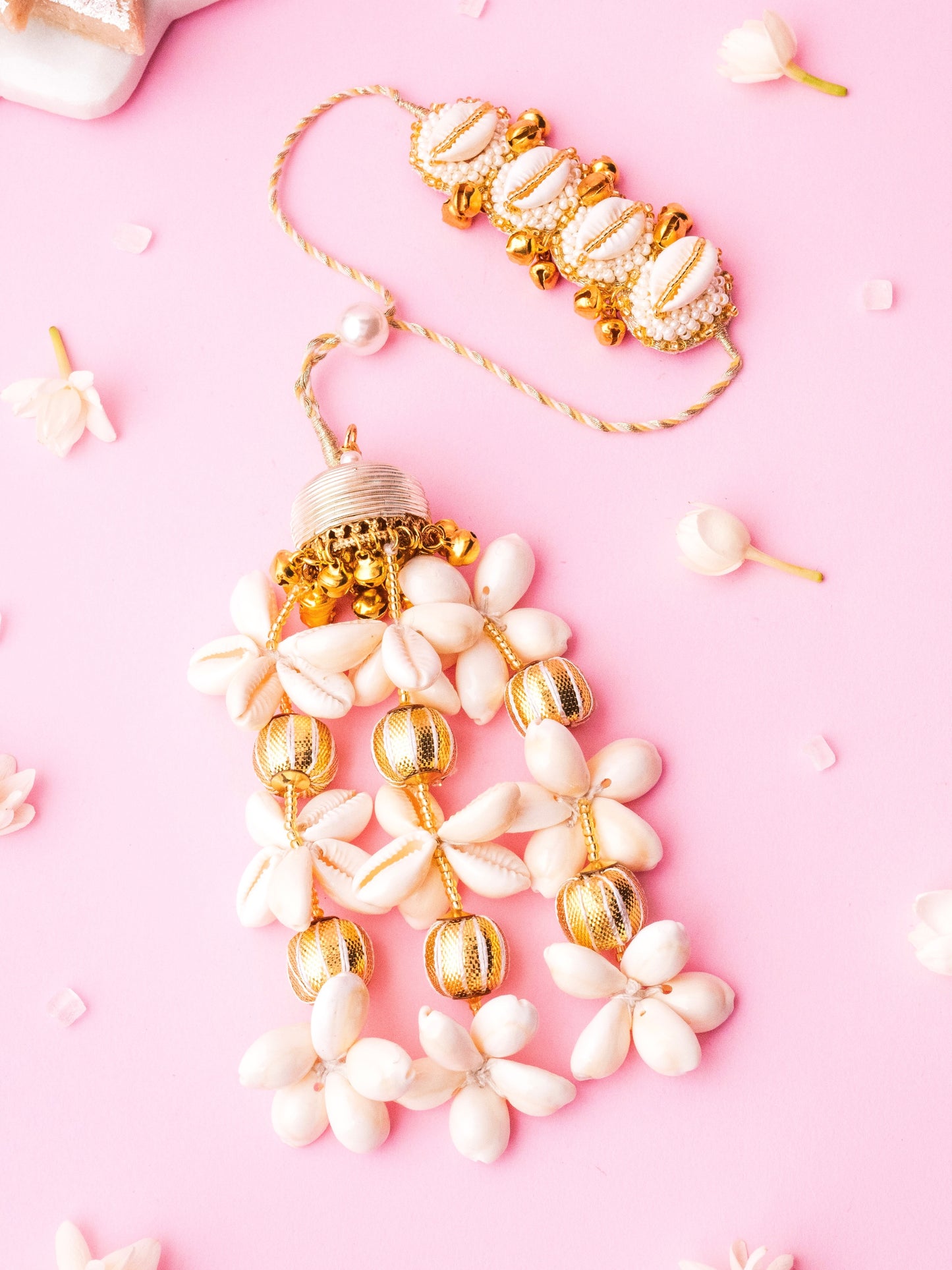 Decorative ivory lumba rakhi with cowrie details 