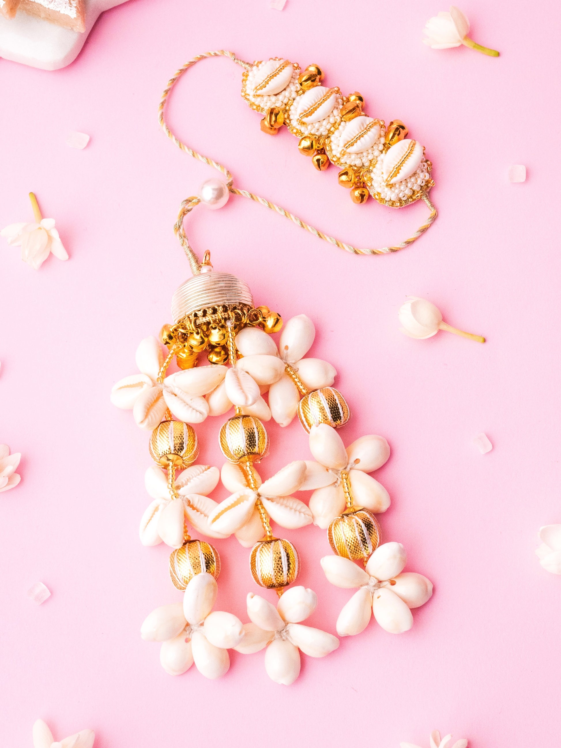 Decorative ivory lumba rakhi with cowrie details 