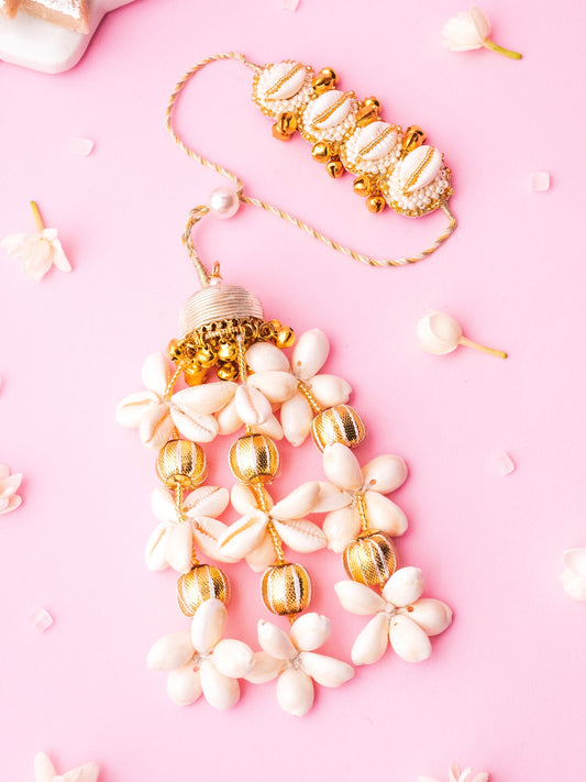 Decorative ivory lumba rakhi with cowrie details 