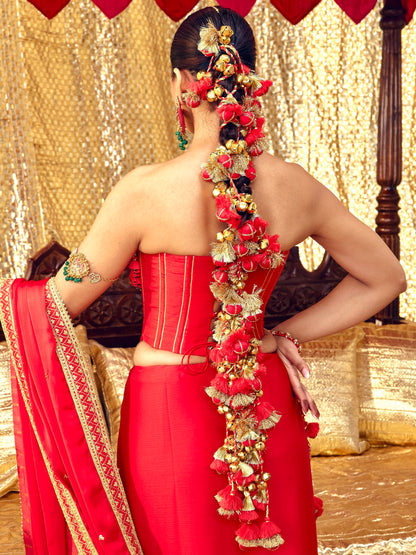 Long Laal Ishq Parandi with red floral elements, tassels and gold-toned details styled along a braid