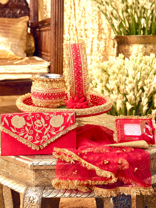 Tota Maina red Karwa Chauth pooja hamper displayed as a coordinated handcrafted set