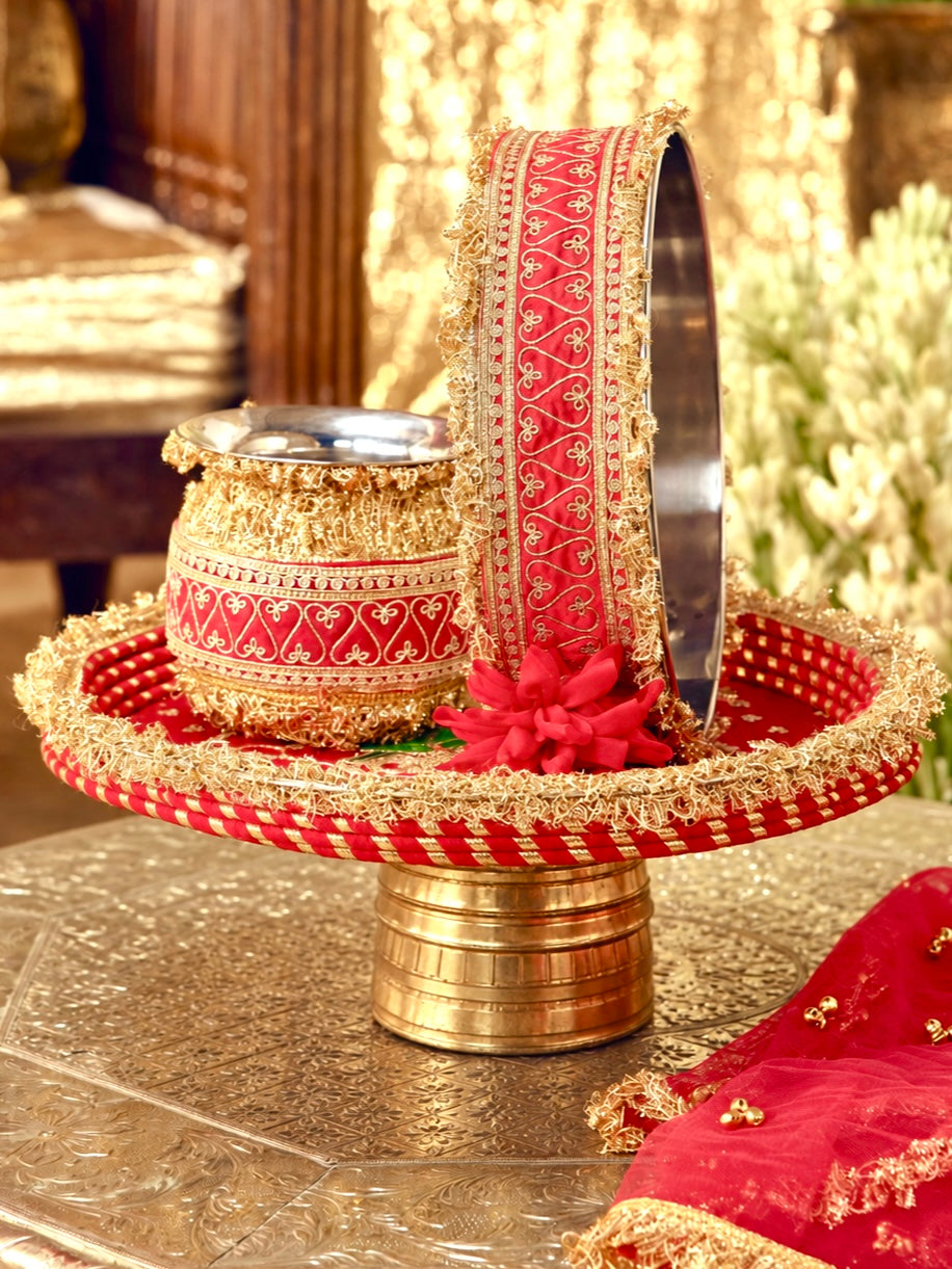 Tota Maina red Karwa Chauth pooja hamper displayed as a coordinated handcrafted set