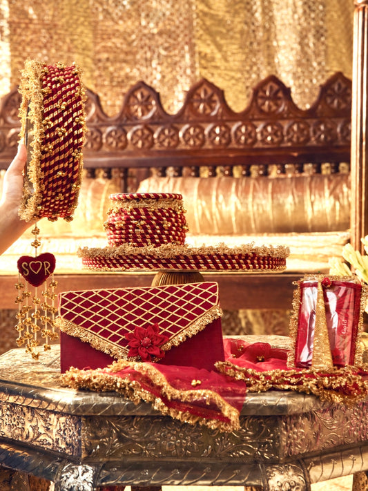 Kumkum maroon Karwa Chauth pooja hamper displayed as a coordinated handcrafted set