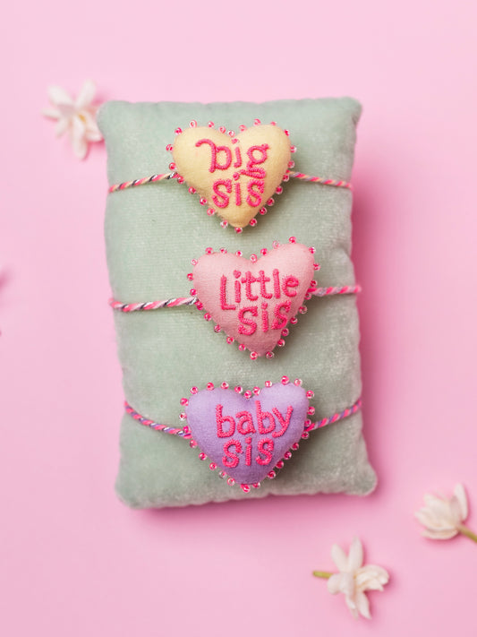 Decorative sister rakhi combo with heart-shaped 3D big sis, little sis and baby sis text