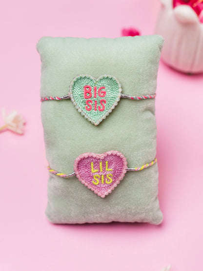Decorative sister rakhi with heart-shaped big sis and lil sis text