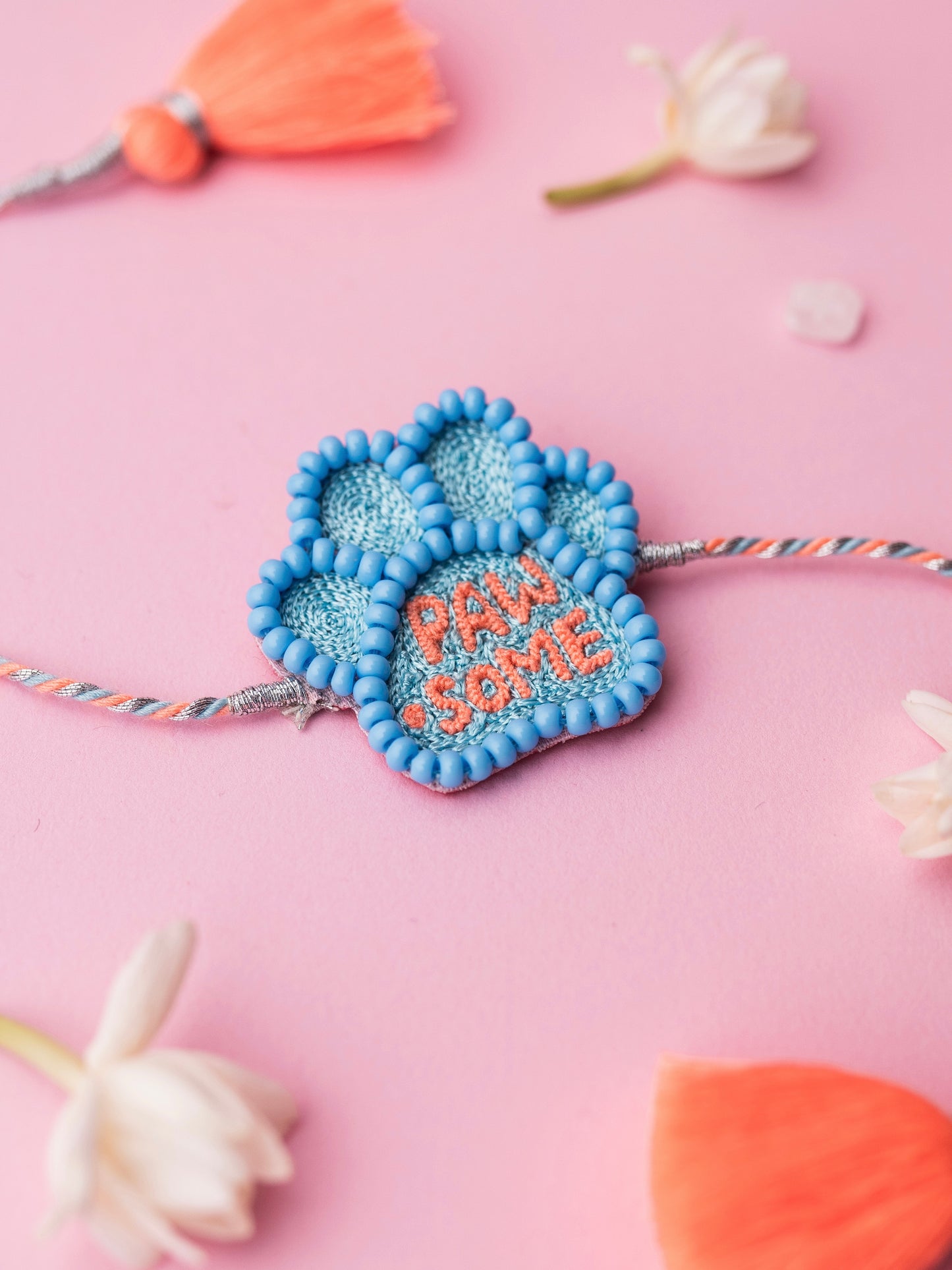 Decorative pet rakhi with pawsome text
