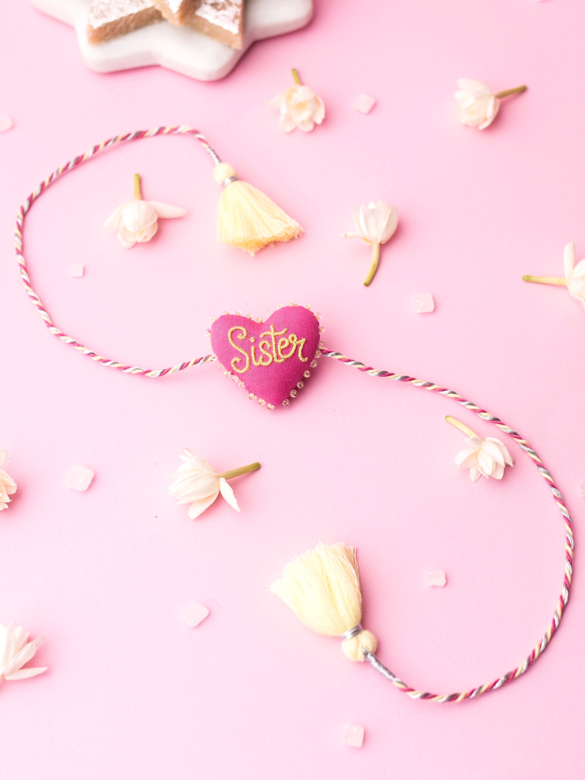 Decorative sister rakhi with heart-shaped 3D sister text