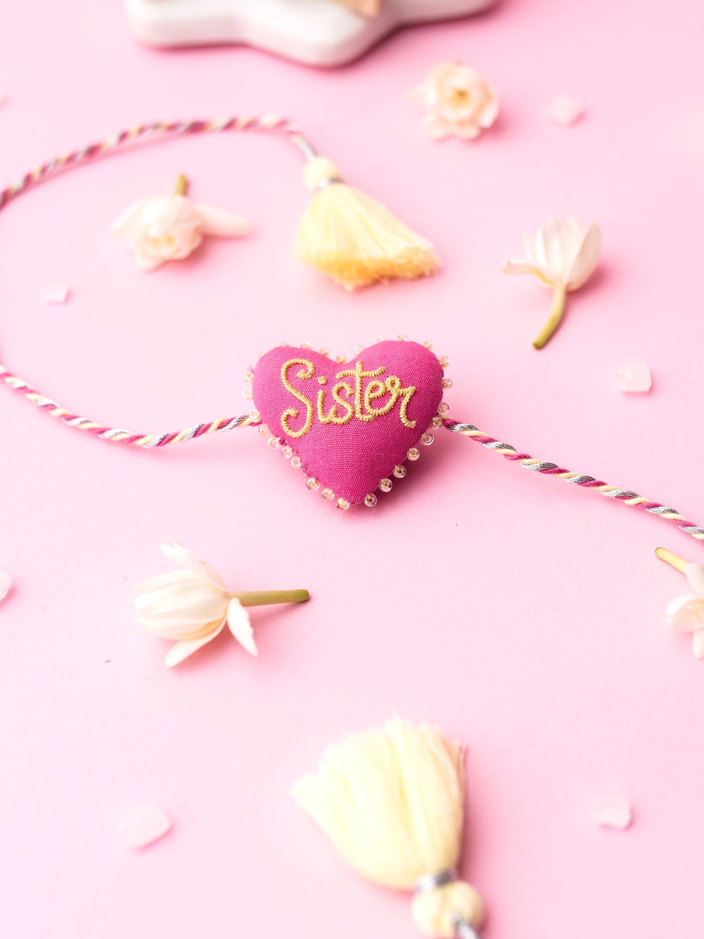 Decorative sister rakhi with heart-shaped 3D sister text