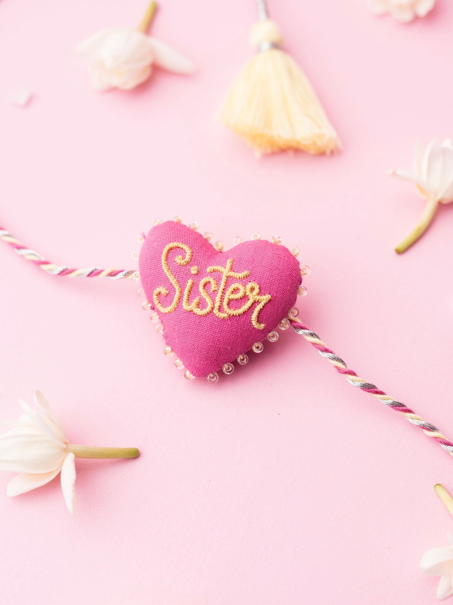 Decorative sister rakhi with heart-shaped 3D sister text