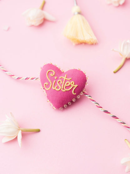 Decorative sister rakhi with heart-shaped 3D sister text